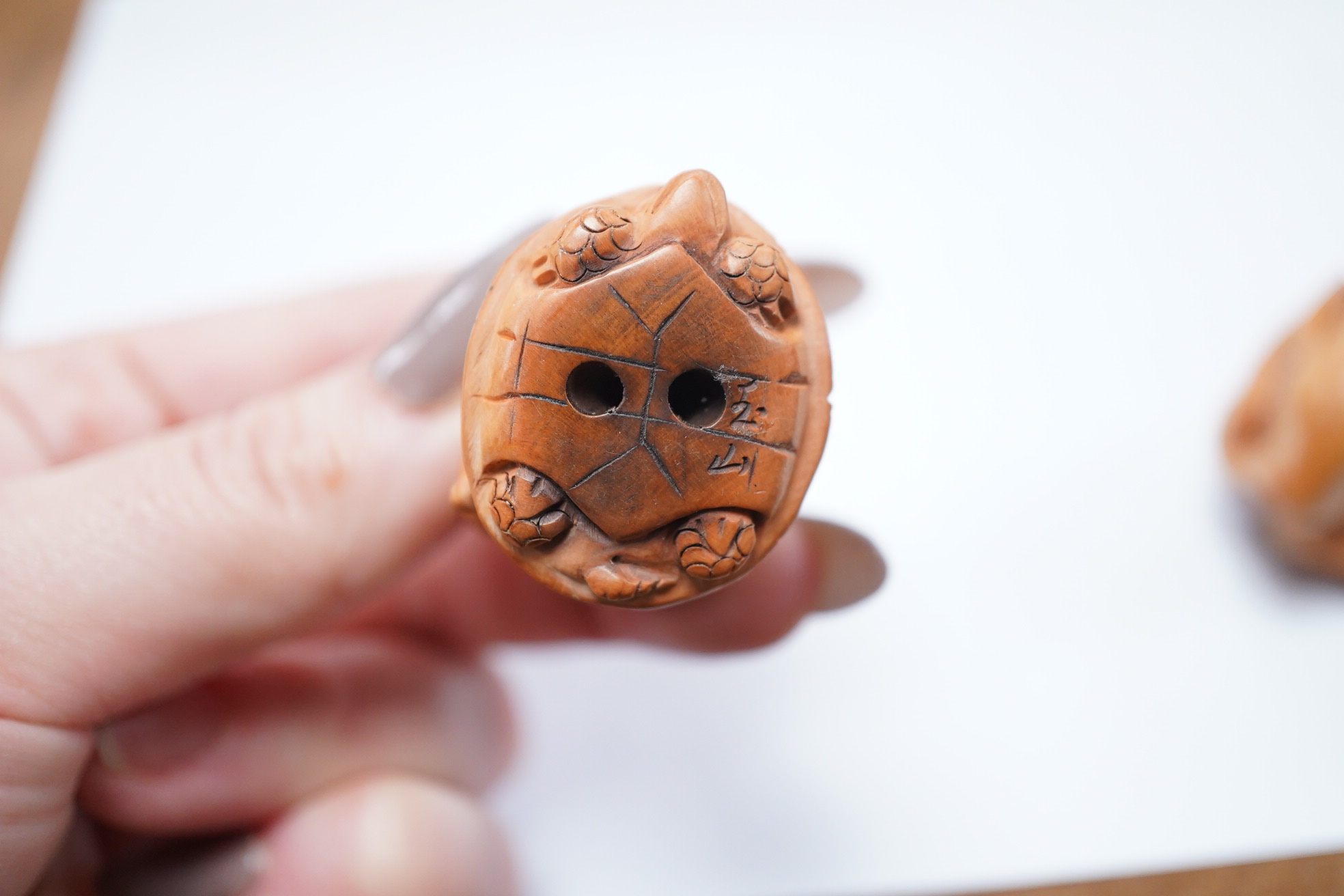 Three Japanese carved and signed boxwood netsukes, largest 5cm. Condition - two tortoises missing heads